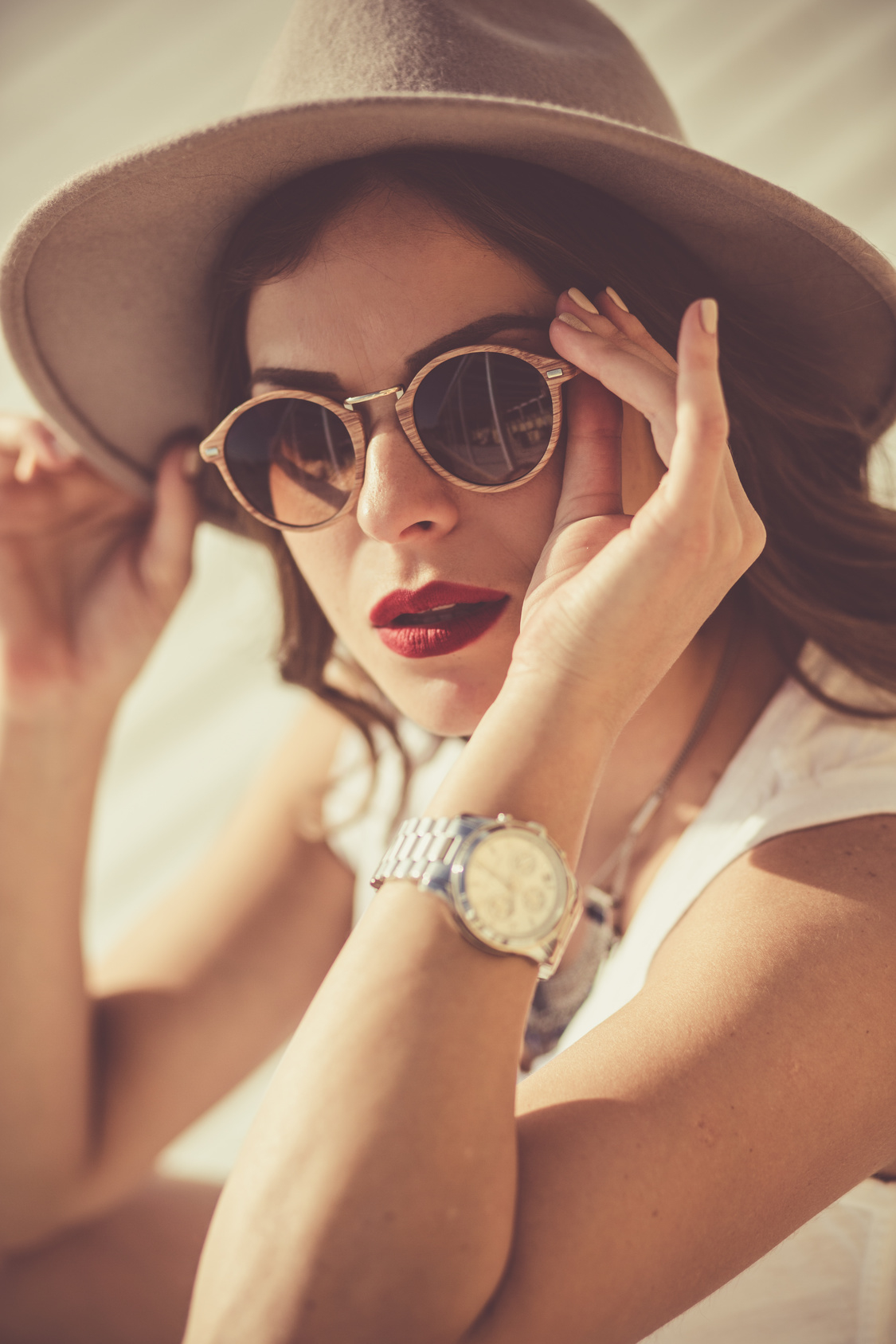 Stylish woman at the summer beach in a hot day